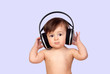 Adorable baby girl with big headphones