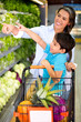 Woman grocery shopping with her kid