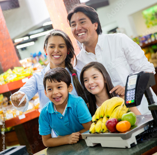 Photo: Family paying at the supermarket Family paying at the supermarket