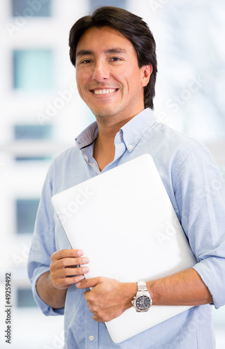 Photo: Executive holding a laptop Executive holding a laptop