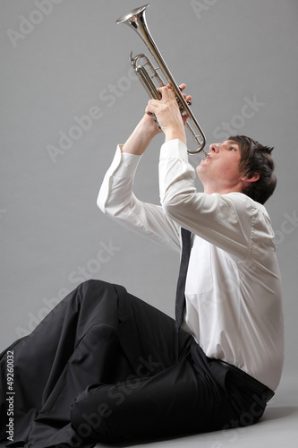 Photo: Portrait of a young man playing his Trumpet Portrait of a young man playing his Trumpet