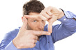 A man looking and focusing through his hands
