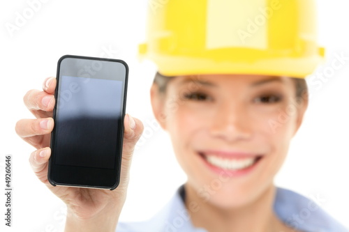Photo: Engineer woman showing smart phone Engineer woman showing smart phone