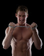 Photo: man tearing a chain. isolated on dark man tearing a chain. isolated on dark