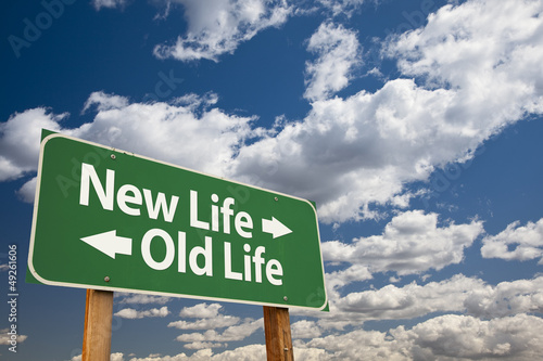 Photo: New Life, Old Life Green Road Sign Over Clouds New Life, Old Life Green Road Sign Over Clouds