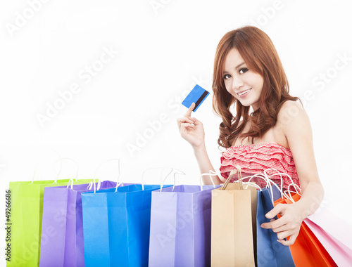 Photo: beautiful young woman holding credit card with shopping bags beautiful young woman holding credit card with shopping bags