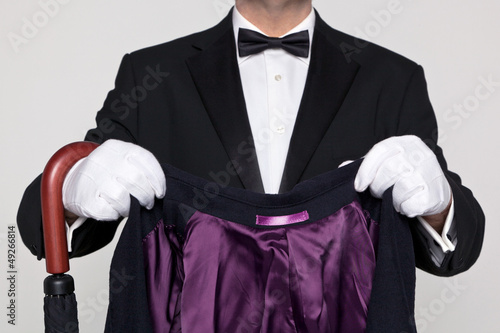 Photo: Butler holding your coat and umbrella. Butler holding your coat and umbrella.