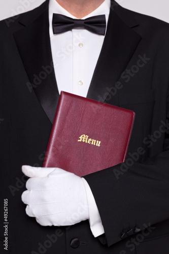 Photo: Waiter holding a Menu Waiter holding a Menu