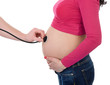 The belly of pregnant young woman with stethoscope