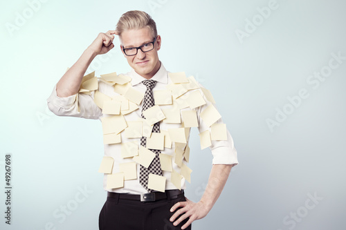 Photo: Puzzled businessman with stickers attached to his shirt. Puzzled businessman with stickers attached to his shirt.