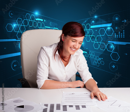 Photo: Businesswoman doing paperwork with futuristic background Businesswoman doing paperwork with futuristic background