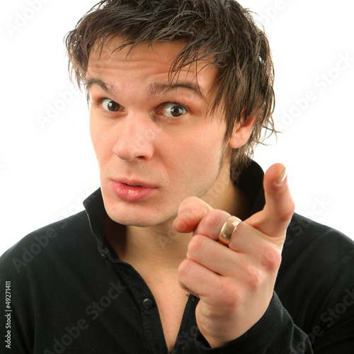 Photo: Portrait of young man showing finger Portrait of young man showing finger