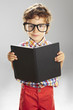 Child who wears plaid shirt with a book in hands