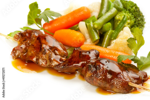 Photo: Grilled meat and vegetables on white background Grilled meat and vegetables on white background