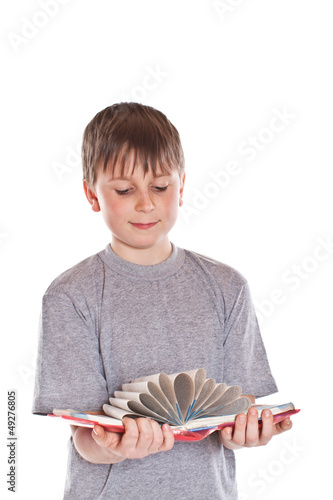 Photo: boy looks at the book boy looks at the book