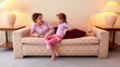 Video: Mother lies on sofa and talk with her daughter sits near Mother lies on sofa and talk with her daughter sits near