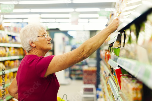 Photo: Senior woman at supermarket. Senior woman at supermarket.