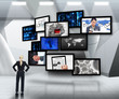 Businesswoman looking up at screens