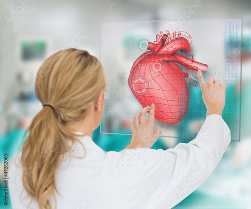 Photo: Doctor consulting touchscreen displaying heart diagram Doctor consulting touchscreen displaying heart diagram