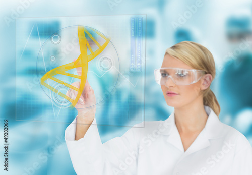 Photo: Doctor consulting DNA helix diagram on touchscreen display Doctor consulting DNA helix diagram on touchscreen display