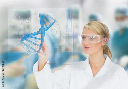 Photo: Doctor consulting touchscreen displaying DNA helix diagram Doctor consulting touchscreen displaying DNA helix diagram
