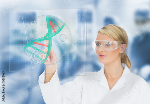 Photo: Doctor using touchscreen displaying DNA helix diagram Doctor using touchscreen displaying DNA helix diagram