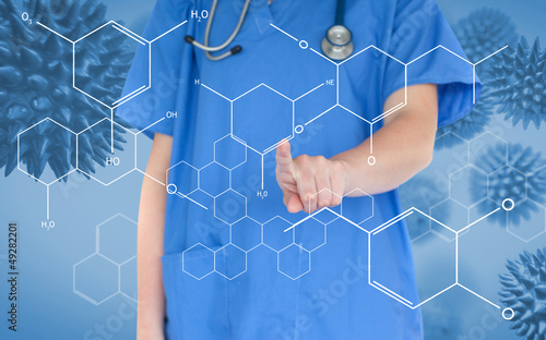 Photo: Doctor pressing touchscreen displaying chemical formula Doctor pressing touchscreen displaying chemical formula