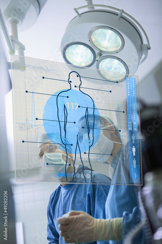 Photo: Two surgeons working with a medical interface Two surgeons working with a medical interface