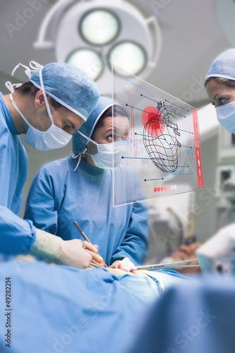 Photo: Surgeons using an interface for operating Surgeons using an interface for operating