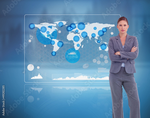 Photo: Businesswoman standing against a futuristic screen Businesswoman standing against a futuristic screen