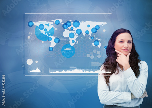 Photo: Businesswoman looking at statistics in the world Businesswoman looking at statistics in the world