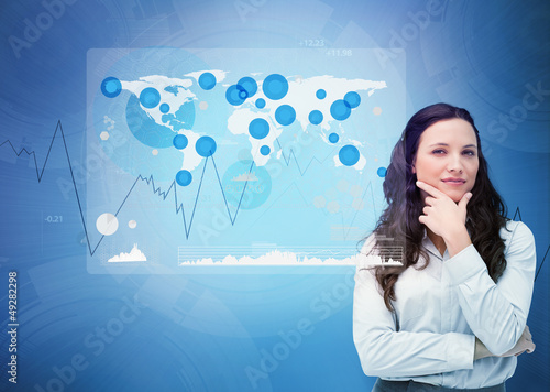 Photo: Businesswoman looking at digital futuristic interface Businesswoman looking at digital futuristic interface