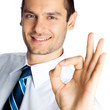 Businessman with okay gesture, isolated
