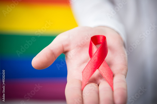Photo: Man holding red awareness ribbon Man holding red awareness ribbon