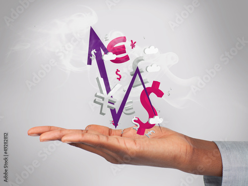 Photo: Businessman holding smoking currency and arrow in his hand Businessman holding smoking currency and arrow in his hand