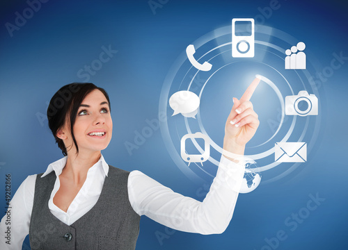 Photo: Businesswoman using circle interface of applications Businesswoman using circle interface of applications