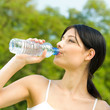 Portrait of woman drinking water outdoor