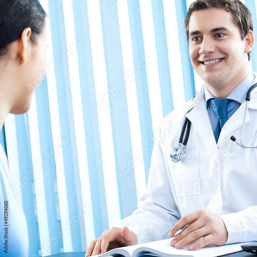 Photo: Portrait of smiling doctor and female patient Portrait of smiling doctor and female patient