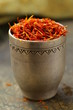 Saffron spice in metal bowl macro shot soft focus