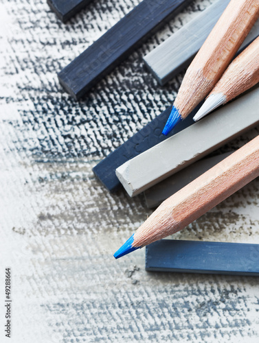 Photo: Close up of gray hard pastels and aquarelle pencils Close up of gray hard pastels and aquarelle pencils