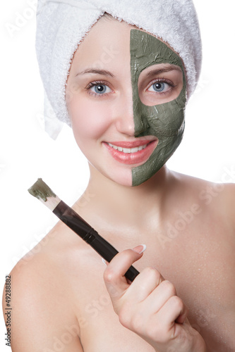 Photo: Young woman with facial mask in beauty spa. Young woman with facial mask in beauty spa.