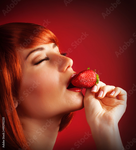 Photo: Seductive female with strawberry Seductive female with strawberry