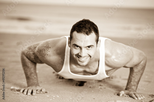 Photo: Male exercising on the beach Male exercising on the beach