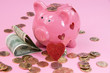 Pink piggy bank with gold coins