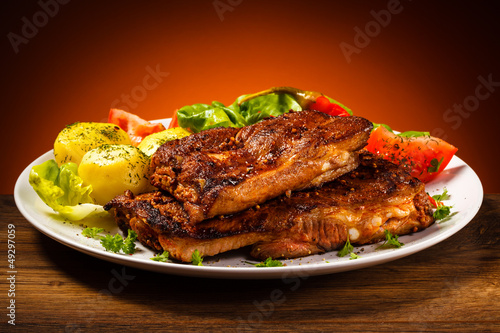 Photo: Tasty grilled ribs with vegetables Tasty grilled ribs with vegetables