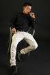 Teenager over black background
