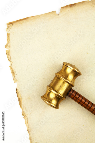 Photo: gavel on old paper gavel on old paper