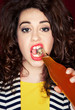 Young beautiful woman trying to open a bottle of drink