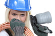 Woman with blow-torch and copper pipe