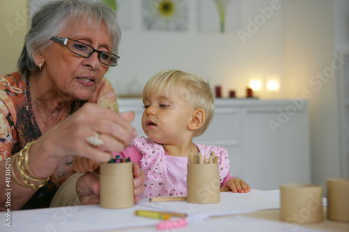 Photo: Young child coloring with grandma Young child coloring with grandma